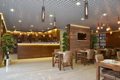 a restaurant with tables and chairs and a bar at The Elegant Hotel in Istanbul