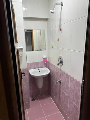a pink and white bathroom with a sink and a mirror at Hotel Semih in Istanbul