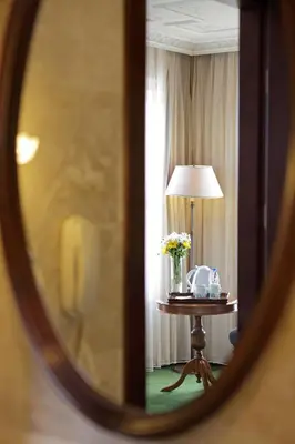 a room with a table with a lamp and flowers at Anemon Koleksiyon Galata Otel in Istanbul