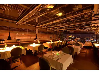 a restaurant with white tables and chairs and lights at Anemon Koleksiyon Galata Otel in Istanbul