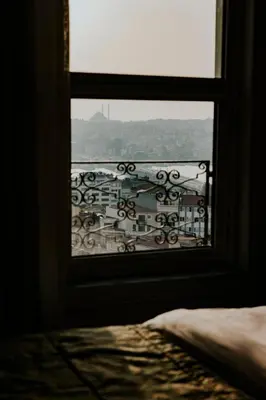 a view of a city from a bedroom window at Anemon Koleksiyon Galata Otel in Istanbul