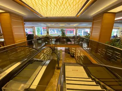 an empty lobby with escalators in a shopping mall at Prestige Hotel Old City in Istanbul