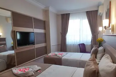 a hotel room with a person laying on a bed at Sembol Hotel in Istanbul