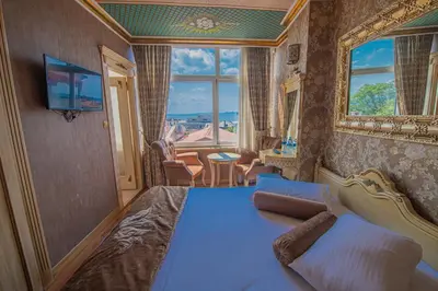 a bedroom with a bed and a large window at Kaftan Hotel in Istanbul