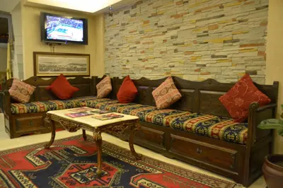 a living room with a couch and a tv at Kaftan Hotel in Istanbul