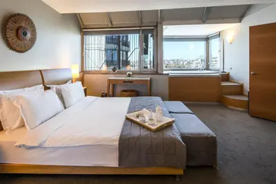 a bedroom with a large bed with a tray on it at Taxim Suites Residences Istanbul in Istanbul