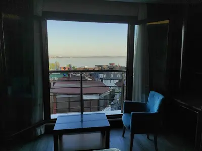 a room with a window with a chair and a view at Magnaura House Hotel in Istanbul