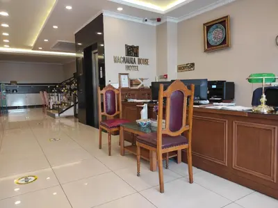 a salon with two chairs and a table and a counter at Magnaura House Hotel in Istanbul