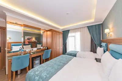 a hotel room with a bed and a desk at Magnaura House Hotel in Istanbul