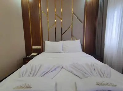 a bedroom with a large bed with white sheets and pillows at The Golden Pera's Hotel & Spa in Istanbul
