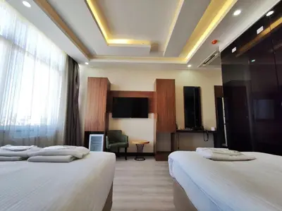 a hotel room with two beds and a flat screen tv at The Golden Pera's Hotel & Spa in Istanbul