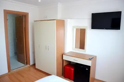 a room with a bed and a tv on the wall at Baran Home Aparts in Istanbul
