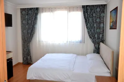 a bedroom with a white bed and a window at Baran Home Aparts in Istanbul