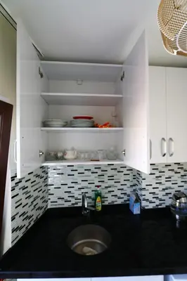 a kitchen with a sink and white cabinets at Oldtown Sultanahmet Suites in Istanbul