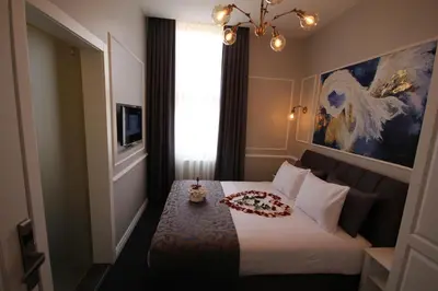 a hotel room with a bed with a candle on it at Hotel Naumpasa Konagi in Istanbul
