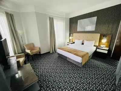 a hotel room with a bed and a chair at City Center Hotel Taksim İstanbul in Istanbul