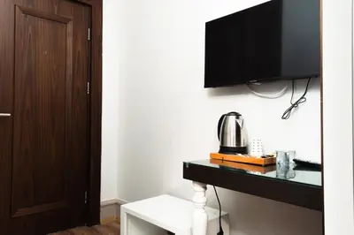 a room with a tv on a wall with a table at City Center Hotel Taksim İstanbul in Istanbul