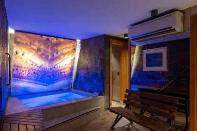 a hot tub in a room with a wooden bench at Tulip City Hotel & Spa in Istanbul