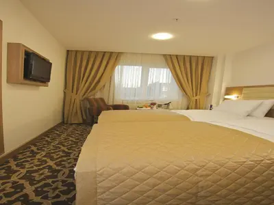a hotel room with two beds and a television at The City Hotel in Istanbul