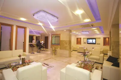 a lobby with white couches and a tv in it at The City Hotel in Istanbul