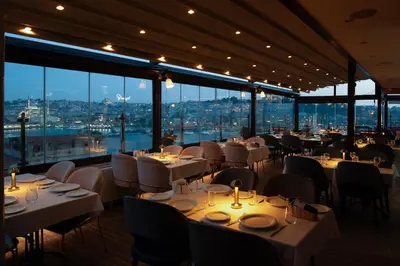 a restaurant with white tables and chairs and large windows at Istanbul Golden City Hotel in Istanbul