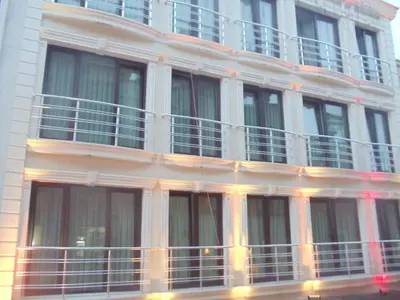 a tall white building with windows and balconies at Ares Hotel in Istanbul