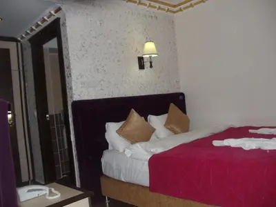a hotel room with a bed and a mirror at Ares Hotel in Istanbul