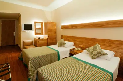 a hotel room with two beds and a television at Hotel Buyuk Keban in Istanbul