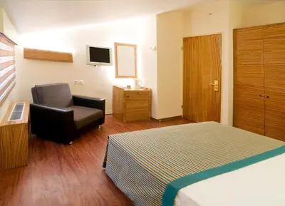 a hotel room with a bed and a chair at Hotel Buyuk Keban in Istanbul