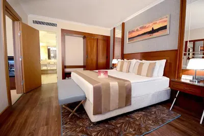 a bedroom with a large bed and a desk at Akgun Istanbul Hotel, WorldHotels Elite in Istanbul