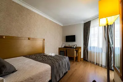 a hotel room with a bed and a television at Levent Hotel Istanbul in Istanbul