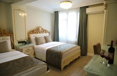 a hotel room with two beds and a window at Best Town Hotel in Istanbul