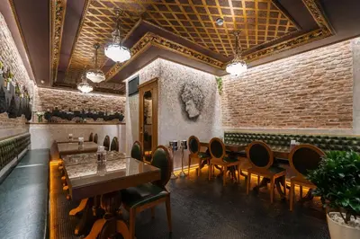 a restaurant with tables and chairs and a brick wall at Tria Elegance Istanbul in Istanbul