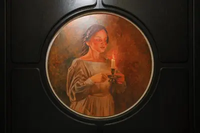 a painting of a woman holding a candle at Tria Elegance Istanbul in Istanbul
