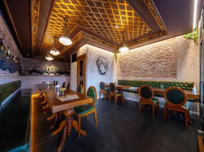 a dining room with tables and chairs and a brick wall at Tria Elegance Istanbul in Istanbul
