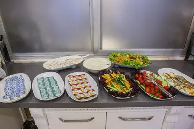 a counter with plates of food and bowls of food at Gulec Hotel & Spa - Special Category in Istanbul