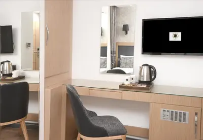 a room with a desk with a tv and a chair at Gulec Hotel & Spa - Special Category in Istanbul
