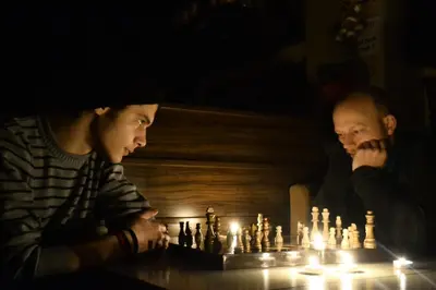 two men sitting at a table playing chess at Second Home Hostel in Istanbul