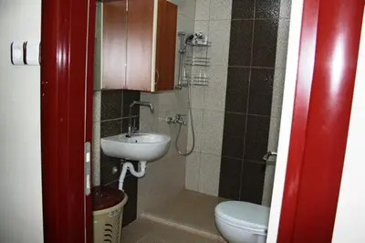 a small bathroom with a sink and a toilet at Bandirma Saglik Apart in Bandırma