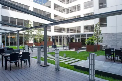 a patio with tables and chairs in a building at ISG Sabiha Gökçen Airport Hotel in Istanbul