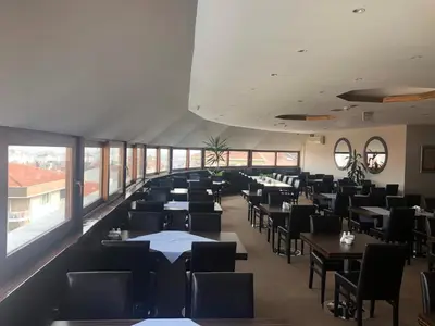 a dining room with tables and chairs and windows at Hotel Topkapı in Istanbul