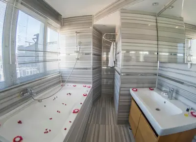 a bathroom with a tub and a sink and a bath tub at Grand Esen Hotel in Istanbul