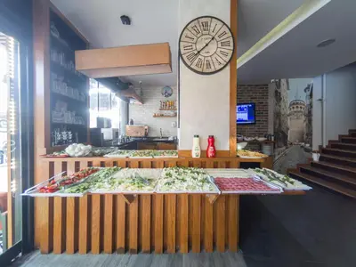a food counter with a large clock on the wall at Grand Esen Hotel in Istanbul