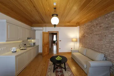 a kitchen and living room with a couch and a table at Catirga Konak Apartments in Istanbul