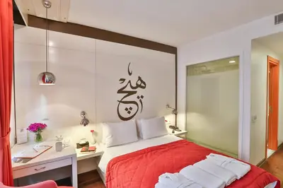 a bedroom with a red bed and a desk at Senatus Hotel - Special Class in Istanbul