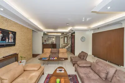 a living room with couches and a tv at May Hotel Istanbul in Istanbul