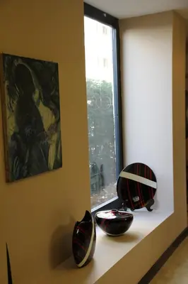 two vases sitting on a shelf next to a window at Airport Residence in Istanbul