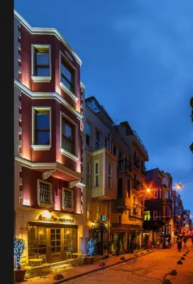 a group of buildings on a city street at night at Amofta Hotel Taksim in Istanbul