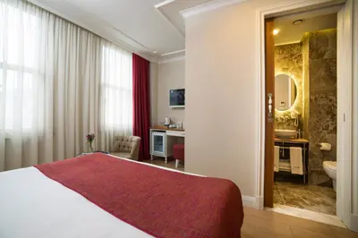 a hotel room with a bed and a bathroom at Amofta Hotel Taksim in Istanbul