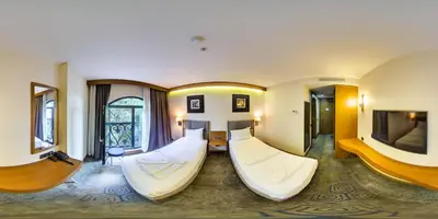 a hotel room with two beds and a television at Yuksel Istanbul Yenikapı Hotel in Istanbul